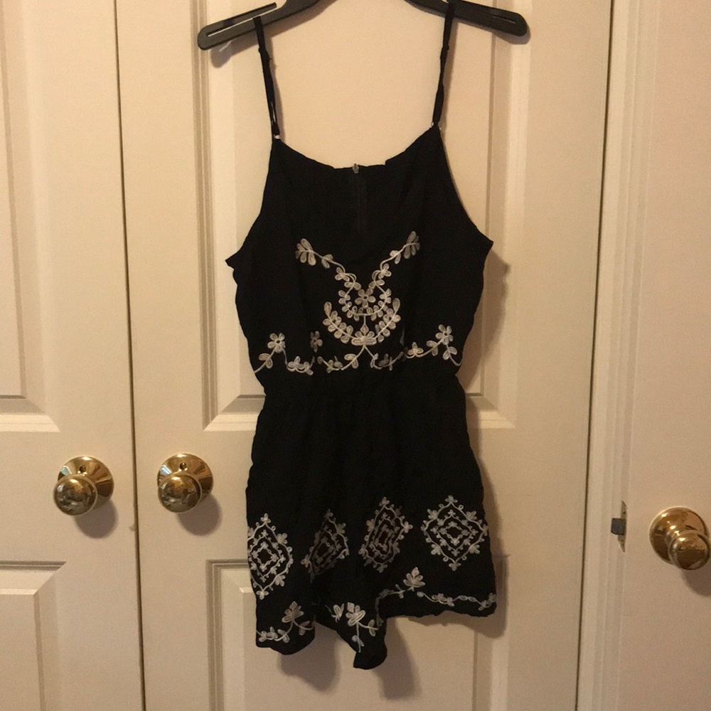 Never worn black romper with white flower design